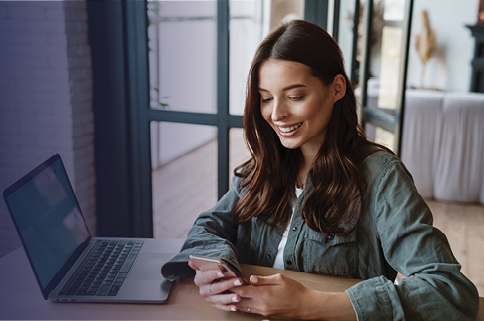 Woman on phone with a laptop
